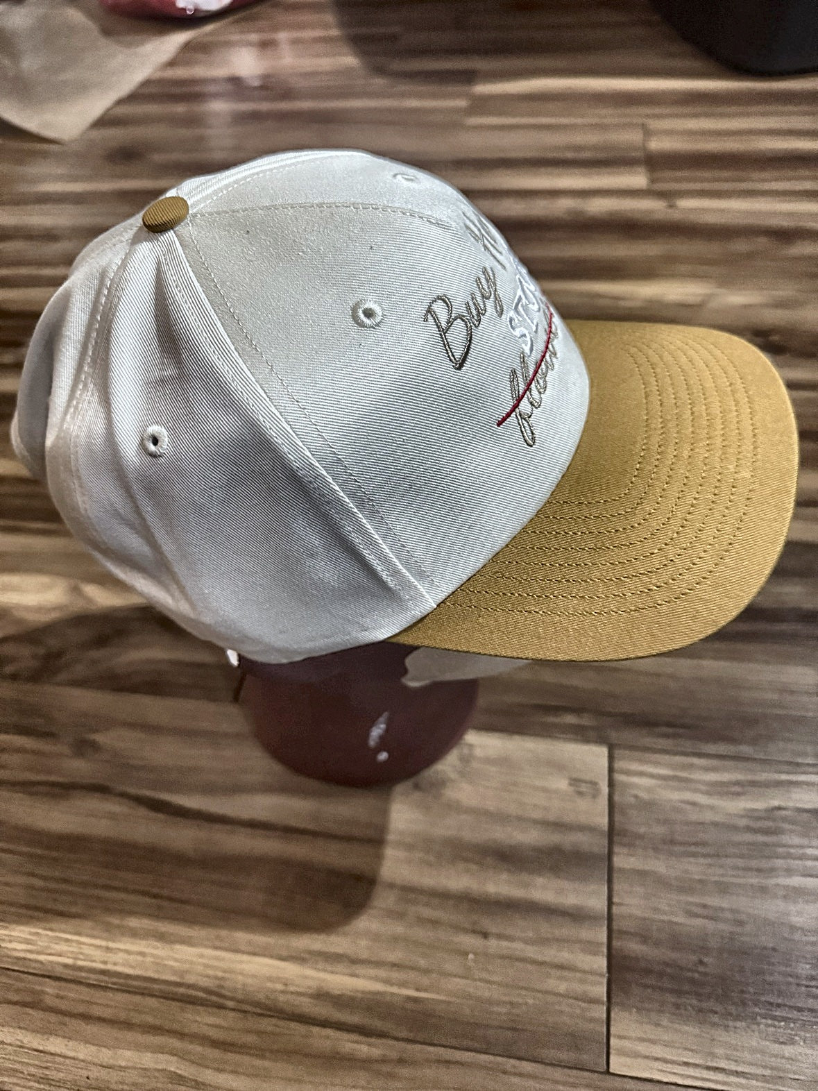 Buy Her Stock Not Flowers hat, side view showing two-tone cream and mustard design